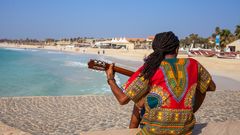 Musician with guitar and rasta hair at Santa Maria Beach, Sal